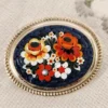 Broche vintage con micromosaico floral sobre base de latón dorado