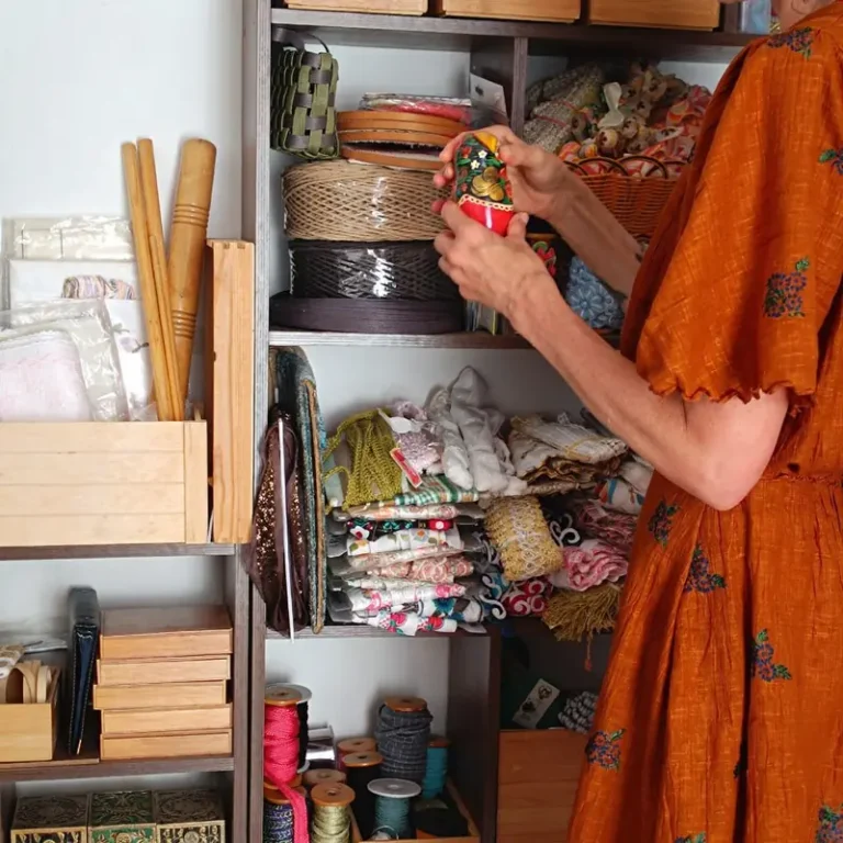 Mujer descubriendo objetos de una estantería en el studio
